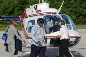 New Light Christian Center megachurch pastor Bishop I.V. Hilliard (sunglasses) exits church helicopter   for which he now seeks a financial seed from members for a blade upgrade. 