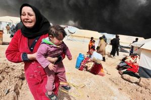 Syrian woman rushes her child from danger.