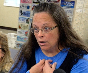 Rowan County Clerk Kim Davis, right, talks with David Moore following her office's refusal to issue marriage licenses at the Rowan County Courthouse in Morehead, Ky., Tuesday, Sept. 1, 2015. Although her appeal to the U.S. Supreme Court was denied, Davis still refuses to issue marriage licenses. (AP Photo/Timothy D. Easley)
